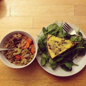 herbed lentils and veggie frittata on a bed of spinach